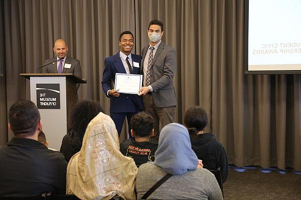 A photo of Darius receiving his Awards for his acts of civic service.